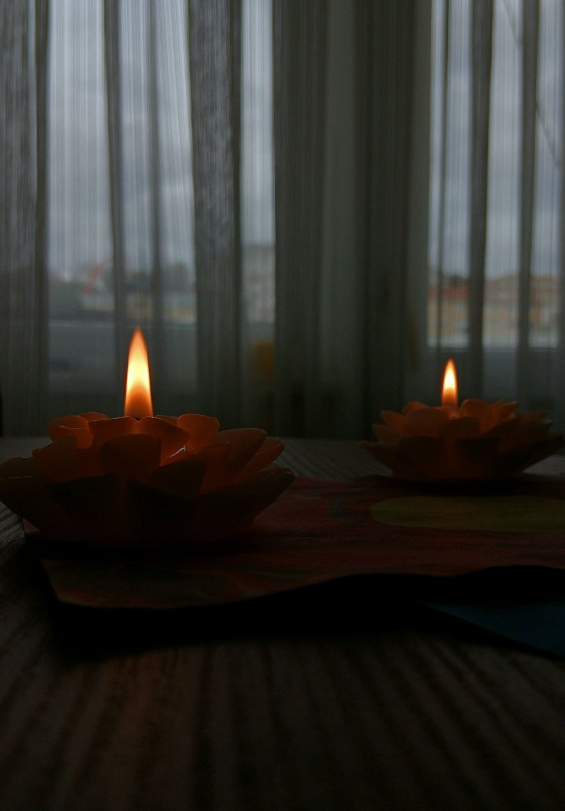 Candles lit on a wooden table during a power outage