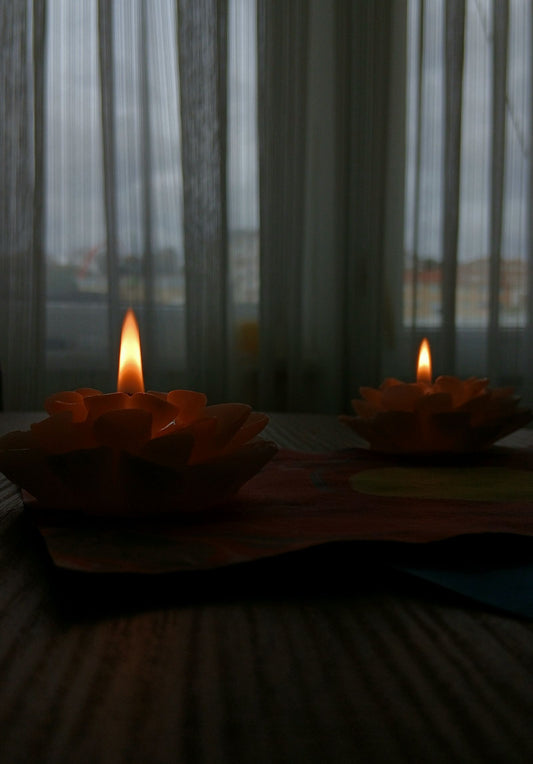 Candles lit on a wooden table during a power outage
